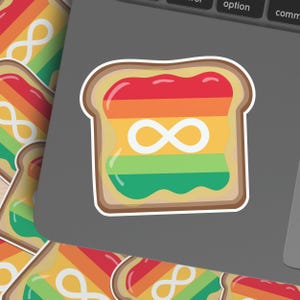 May include: A sticker featuring a slice of toast with rainbow-colored jelly and an infinity symbol. The toast has a brown crust and the jelly is red, orange, yellow, green, and blue. Additional stickers are visible.
