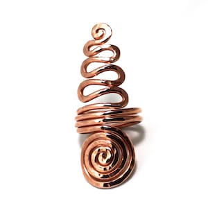 May include: A copper ring with a spiral design. The ring is hammered and has a textured finish.