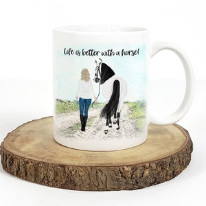 May include: White ceramic mug with a black handle. The mug features a colorful illustration of a woman walking a horse with the text "Life is better with a horse!" printed on the mug.