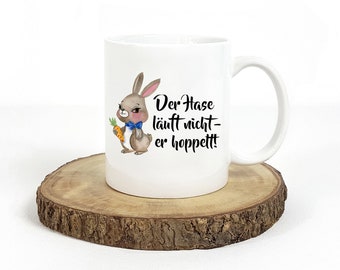 Tasse mit Spruch Der Hase läuft nicht er hoppelt Bedruckte Kaffeetasse mit Häschen Frohe Ostern