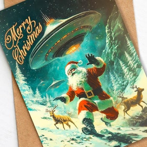 May include: A Christmas card featuring a retro illustration of Santa Claus running through a snowy forest with reindeer. A flying saucer hovers above him, and the text "Merry Christmas" is written in gold script.