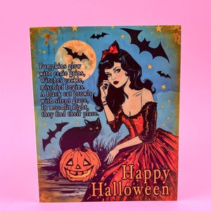 May include: Vintage-style Halloween art print featuring a woman in a red dress, a black cat, and a jack-o'-lantern. The artwork includes bats, a full moon, and the words "Happy Halloween" and a poem.