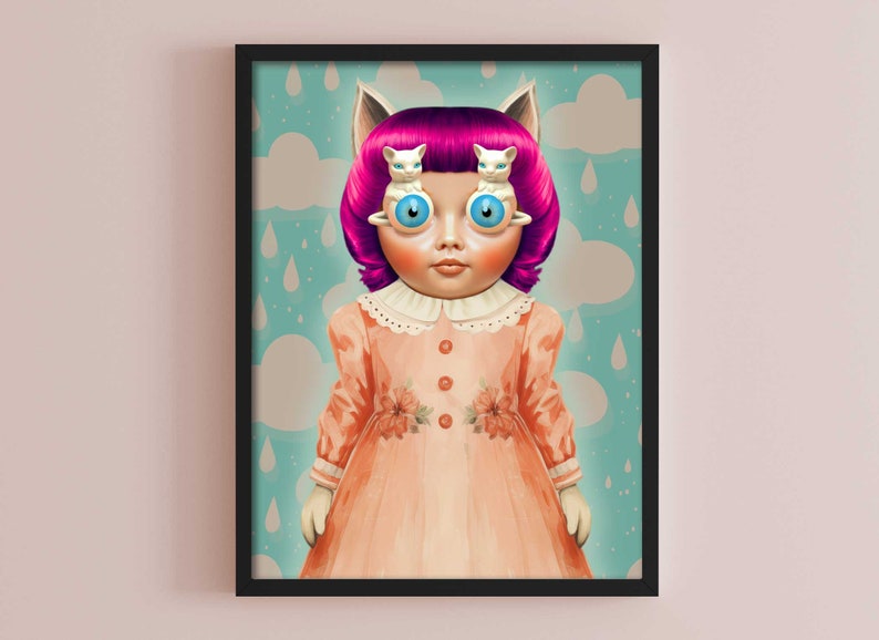 Puede incluir: Una mu&ntilde;eca con pelo rosa y orejas de gato lleva un vestido de color melocot&oacute;n con detalles florales. Los ojos de la mu&ntilde;eca est&aacute;n reemplazados por gatitos blancos.