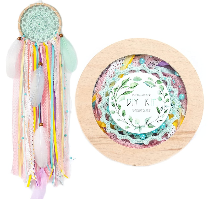 May include: A DIY dreamcatcher kit with a wooden hoop, green and pink crochet lace, colorful ribbons, feathers, and beads. The kit includes instructions for creating a dreamcatcher.
