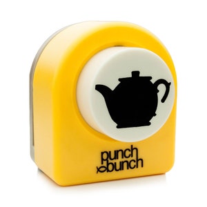 May include: A yellow and white paper punch with a black teapot silhouette. The punch has the words "punch bunch" printed on the side. The punch is designed for crafting and scrapbooking.