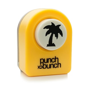 Könnte beinhalten: Gelber Papier-Locher mit Palmenmotiv von Punch Bunch. Der Locher ist ein kleines, handliches Gerät mit einem runden Schneidebereich. Das Palmenmotiv ist schwarz-weiß.