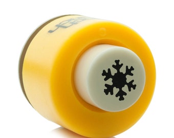 May include: Yellow plastic snowflake punch with a white center and a black snowflake design.