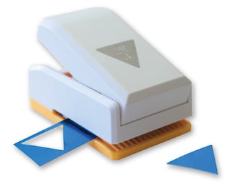 May include: A white plastic triangle punch with a blue triangle punched out. The punch is open and the blue triangle is on the base of the punch.