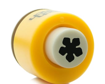 May include: Yellow plastic snowflake punch with a white die and a black snowflake design.