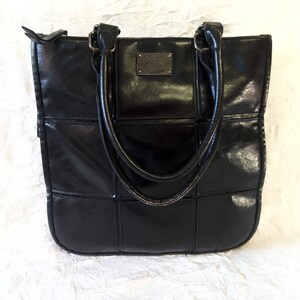 May include: Black quilted tote bag with a silver logo on the front.