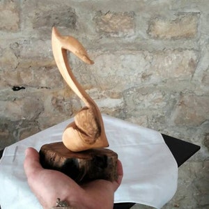 Love tunes. Olive wood sculpture. Wooden music carving. Wooden music sculpture.