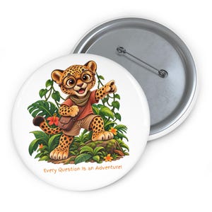May include: A round pin-back button featuring a cartoon leopard wearing glasses, a red shirt, and a brown satchel, standing in a jungle setting with green leaves and orange flowers. The text reads, Every Question Is an Adventure!