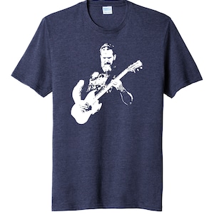 May include: A navy blue t-shirt with a white silhouette of a man playing a guitar.