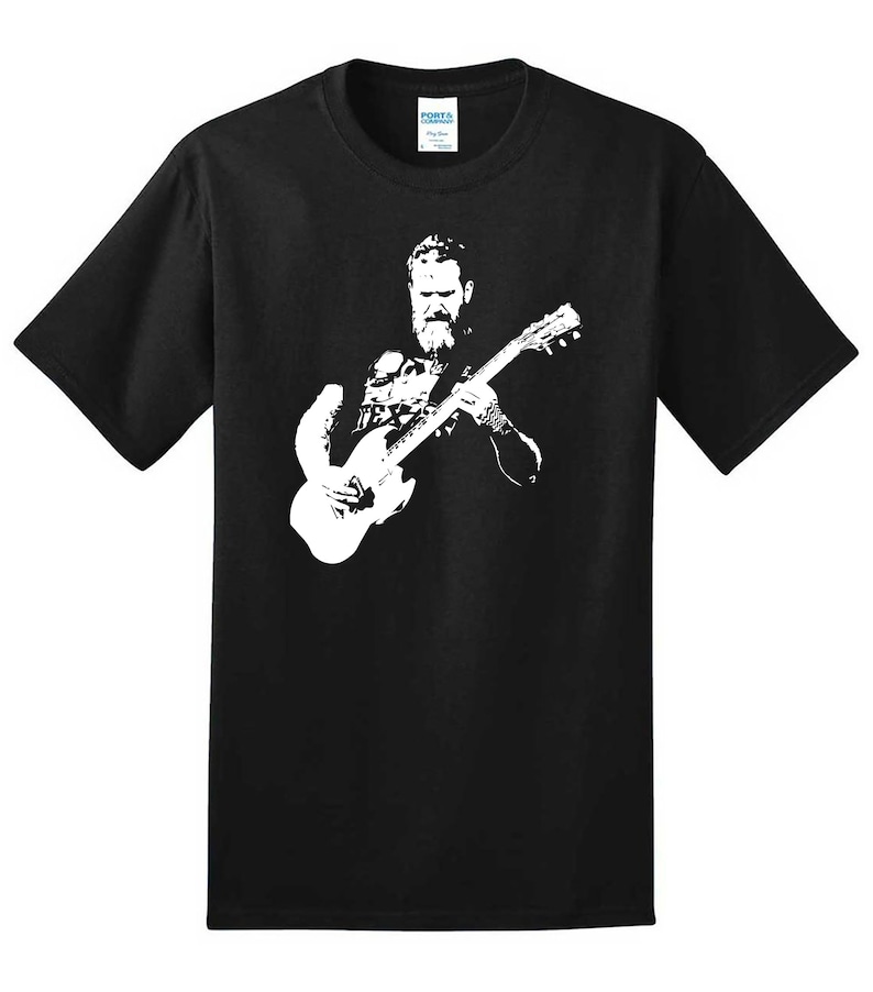 May include: Black t-shirt with a white silhouette of a man playing a guitar.
