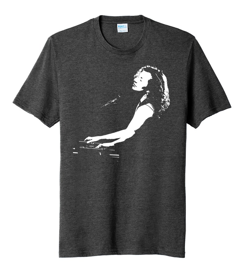 May include: A dark heather grey t-shirt with a white silhouette of a person playing a keyboard.