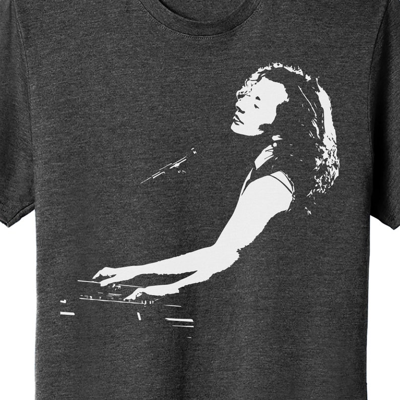 May include: A black and white silhouette of a person playing a keyboard. The person is wearing a sleeveless shirt and has long hair. The keyboard is a standard keyboard with black and white keys.
