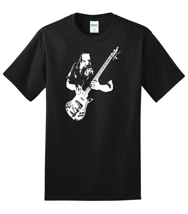 May include: Black t-shirt with a white silhouette of a musician playing a bass guitar.