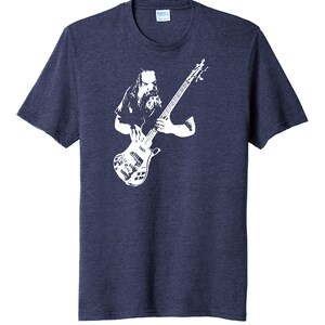 May include: A navy blue t-shirt with a white silhouette of a musician playing a bass guitar.