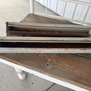 May include: A rustic wooden sign with the text "Welcome to our home" in a handwritten style. The sign is rectangular, with a distressed finish, and features a simple, inviting design. It's suitable for indoor or outdoor use.