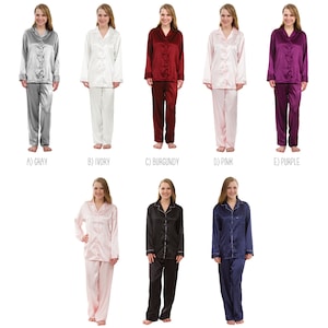 May include: A selection of ten different pajama sets in various colors, including gray, ivory, burgundy, pink, purple, blush, black, and navy. Each set features a long-sleeved top and matching pants. Some sets have white trim or a pocket.