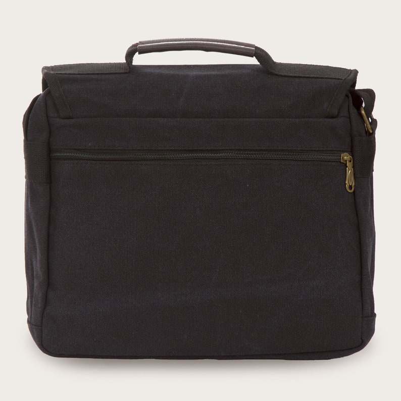 May include: A black canvas messenger bag with a brown leather handle and a zippered pocket on the front. The bag has a shoulder strap.