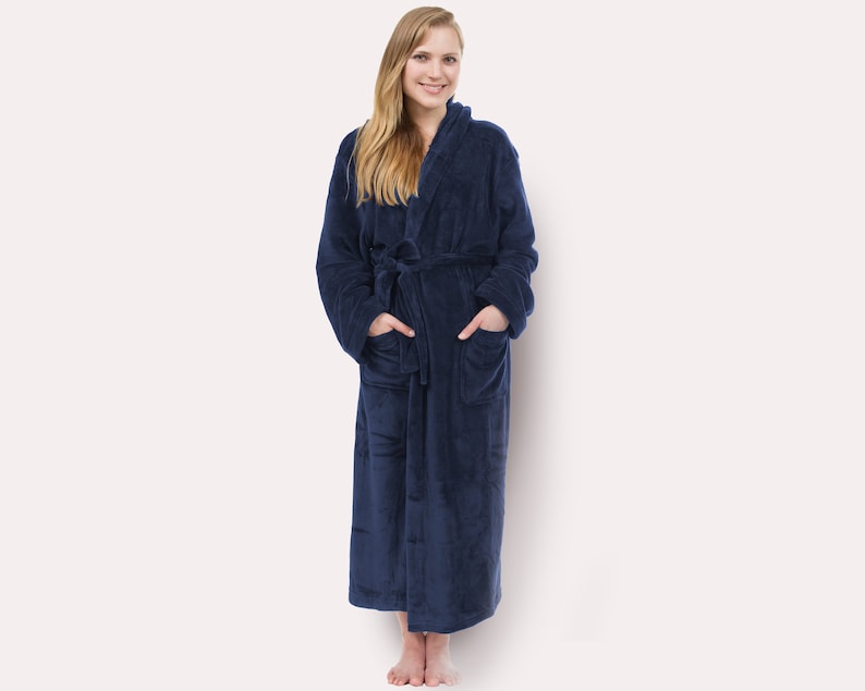 May include: A long, navy blue robe with a hood and pockets. The robe is made of a soft, plush material.