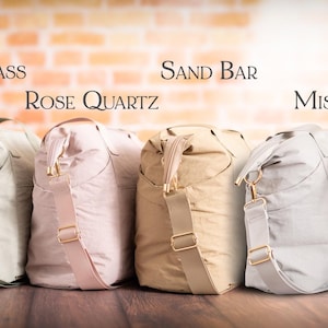 May include: A row of premium style bags in various colors, including white, orange, gray, pink, beige, light gray, black, and navy blue. Each bag has a shoulder strap and gold-colored hardware. The text "Style 2 (Premium)" is at the top.