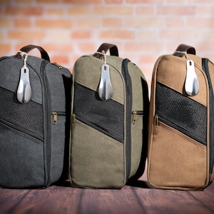 May include: Three canvas shoe bags with zipper closures and mesh panels. The bags are in grey, green, and brown.