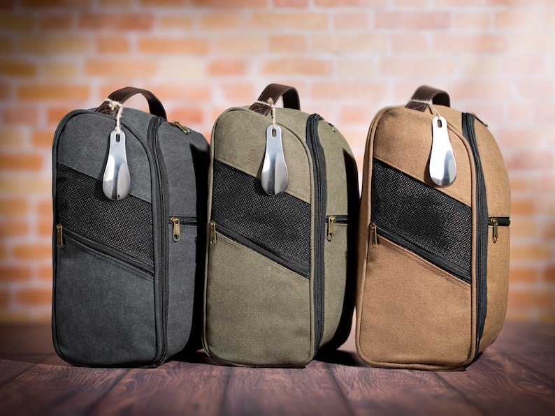 May include: Three canvas shoe bags with zipper closures and mesh panels. The bags are in grey, green, and brown.