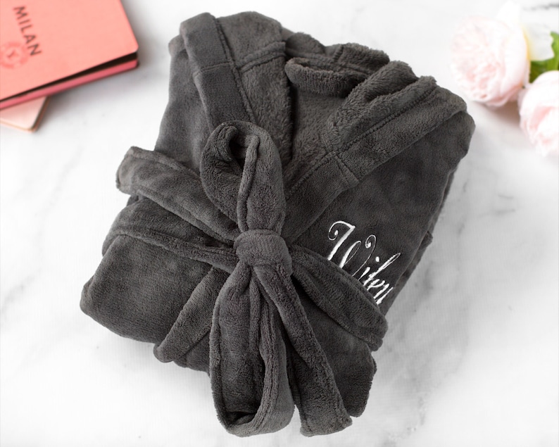May include: A gray plush robe with a white embroidered name "Witen" on the front.