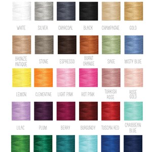 May include: A color chart for Joyful Tidings Bridal Boutique displaying thirty spools of embroidery thread in various shades including white, silver, charcoal, black, champagne, gold, bronze, stone, espresso, burnt orange, sage, misty blue, lemon, clementine, light pink, hot pink, turkish rose, rose gold, lilac, plum, berry, burgundy, tuscan red, caribbean blue, emerald, evergreen, teal, light blue, royal blue, and navy blue.