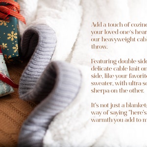 May include: A close-up of a cozy, double-sided fleece throw. One side features a delicate cable knit, the other a plush sherpa. The throw is gray and white, with gift-wrapped presents in the background. Text on the image reads: "Add a touch of coziness..."