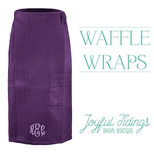 May include: Purple waffle weave wrap with a pocket and a monogrammed "REL" in white. The wrap is a bridal boutique product and the text "Waffle Wraps" and "Joyful Tidings Bridal Boutique" is visible in the image.