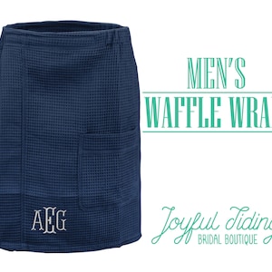 May include: A navy blue waffle weave bath wrap with a single pocket and a monogrammed initial "AEG". The text "MEN'S WAFFLE WRAPS" and "Joyful Tidings BRIDAL BOUTIQUE" is visible in the image.