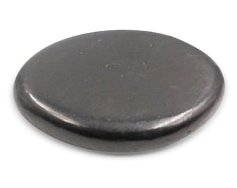 May include: A dark gray, oval-shaped metal plug. The plug has a smooth, slightly reflective surface and rounded edges. It is designed to fit into a hole or opening, likely for sealing or covering purposes. The object is shown against a white background.