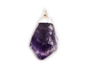 May include: A purple amethyst crystal pendant with a silver bail. The crystal is rough and has a natural, irregular shape.