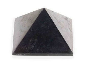 May include: A black and gray pyramid-shaped decorative object. The pyramid has a square base and a triangular top. The object is made of a stone-like material with a marbled appearance. The pyramid is set against a white background.