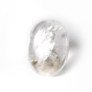 May include: A clear, oval-shaped crystal with a cloudy, white interior. The crystal is smooth and polished.