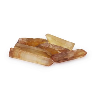May include: A group of six raw, unpolished, golden brown quartz crystals. The crystals are pointed and have a natural, rough texture.