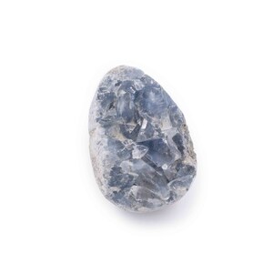 May include: A blue celestite crystal cluster with a rough, natural texture. The crystal is a light blue color and has a variety of shapes and sizes.