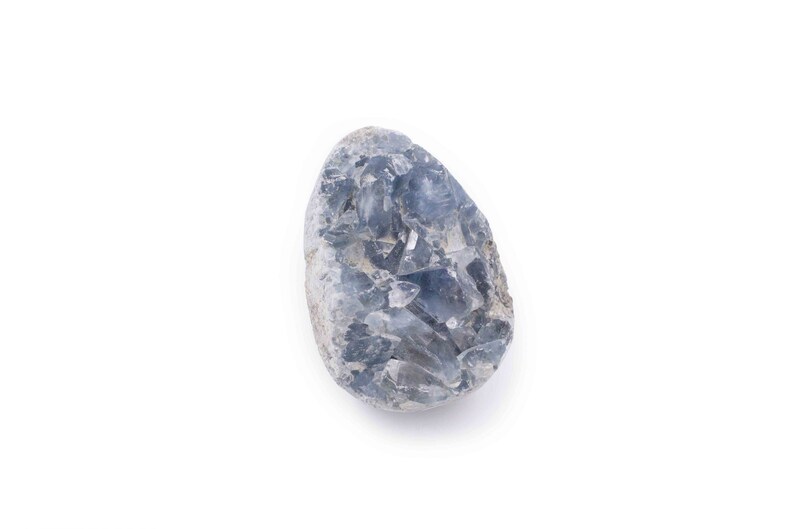May include: A blue celestite crystal cluster with a rough, natural texture. The crystal is a light blue color and has a variety of shapes and sizes.