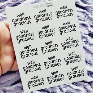 May include: A sheet of stickers with the phrase "well goodness gracious" repeated 12 times in black text on a white background.
