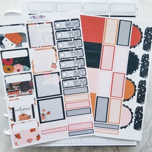 May include: A set of printable planner stickers with a fall theme. The stickers feature pumpkins, fall leaves, and the words "welcome fall". There are also stickers with days of the week and blank boxes for writing.