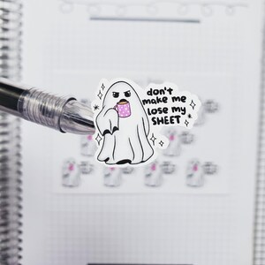 May include: A white ghost with a pink coffee cup and the text "don't make me lose my sheet" in black.