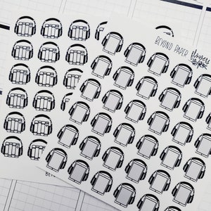 May include: A sheet of black and white stickers featuring illustrations of headphones with books and tablets. The stickers are arranged in a grid pattern and have the text "Beyond Paper Flowers" in the top right corner.