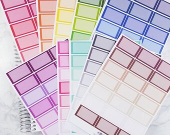 May include: A set of colorful blank label stickers with a variety of colors including pink, purple, blue, green, yellow, and orange. The stickers are arranged in a fan shape and have a white background with a black border. The stickers are labeled "bound paper twins" and "designed by bound paper twins".