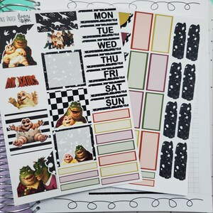 May include: A set of planner stickers featuring characters from the cartoon show 'Dinosaurs'. The stickers include a variety of images, including the characters Baby Sinclair,  Fran Sinclair, and Earl Sinclair. The stickers are printed on white paper with a black and white checkered pattern. The stickers are designed to be used in a planner or journal.