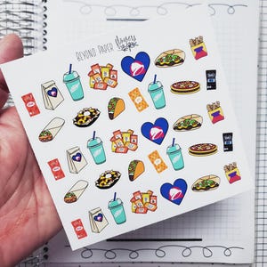 May include: A sheet of stickers featuring various Taco Bell themed designs, including a blue heart with the Taco Bell logo, a blue and white cup, a burrito, a taco, a pizza, a bag of chips, and a red sauce packet. The stickers are on a white background and the text "Beyond Paper Flowers" is printed in the top left corner.