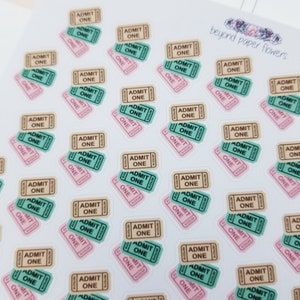 May include: A sheet of stickers featuring multiple ticket-shaped designs. The tickets are in various colors, including pink, brown, and green. The text "ADMIT ONE" is printed on each ticket.