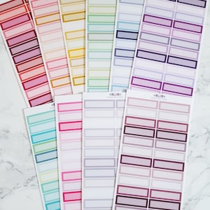 May include: A set of 10 sheets of colorful rectangular label stickers with a white border. The labels are in various shades of red, pink, orange, yellow, green, blue, purple, and gray.